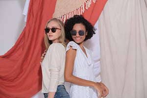 Two girls wearing polarized sunglasses