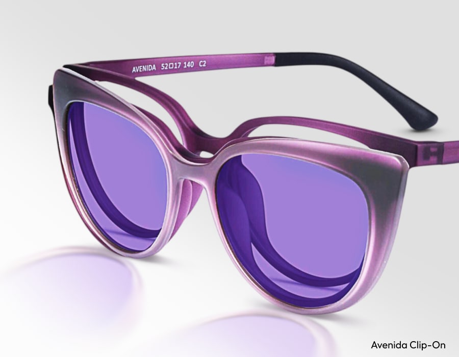 A closeup of clip on sunglasses with violet-tinted lenses