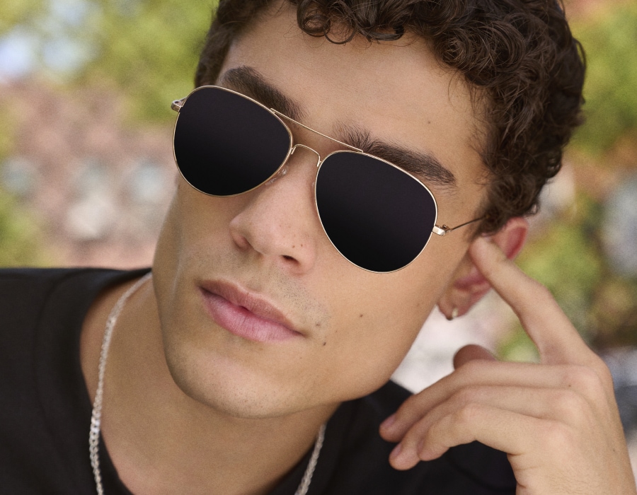 A man wearing glasses with dark transition lenses