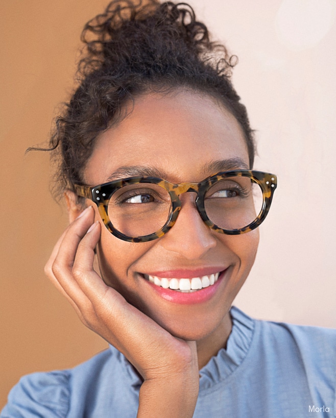 A woman wearing funky reading glasses