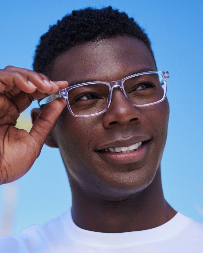 A man wearing clear-frame eyeglasses