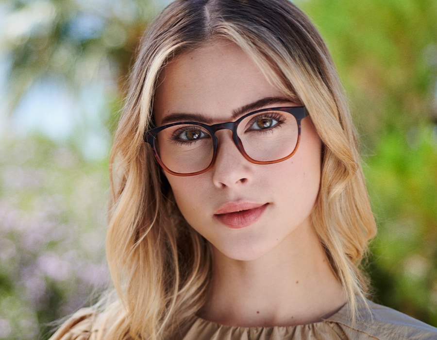 A woman wearing tortoiseshell color eco-friendly glasses