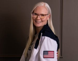 Colleen Young wearing a jacket with an American flag on the sleeve