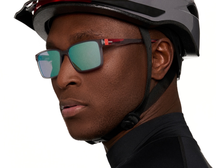 A man wearing a cycling helmet and sunglasses