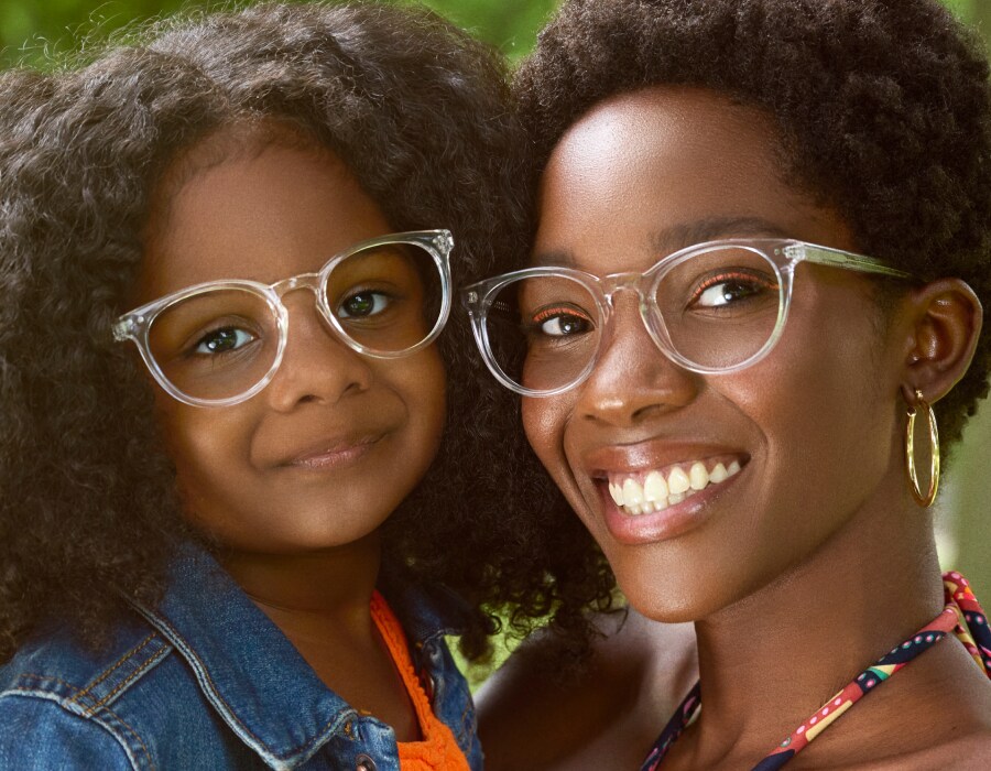 A mother and daughter wearing clear-frame eyeglasses