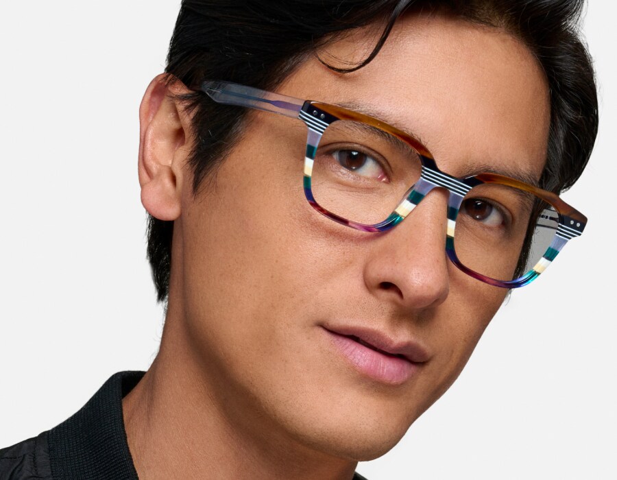 A man wearing eyeglasses with colorful striped frames