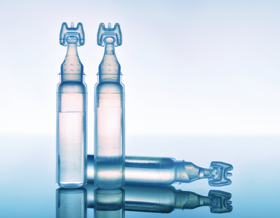 A closeup of three vials of eyedrops