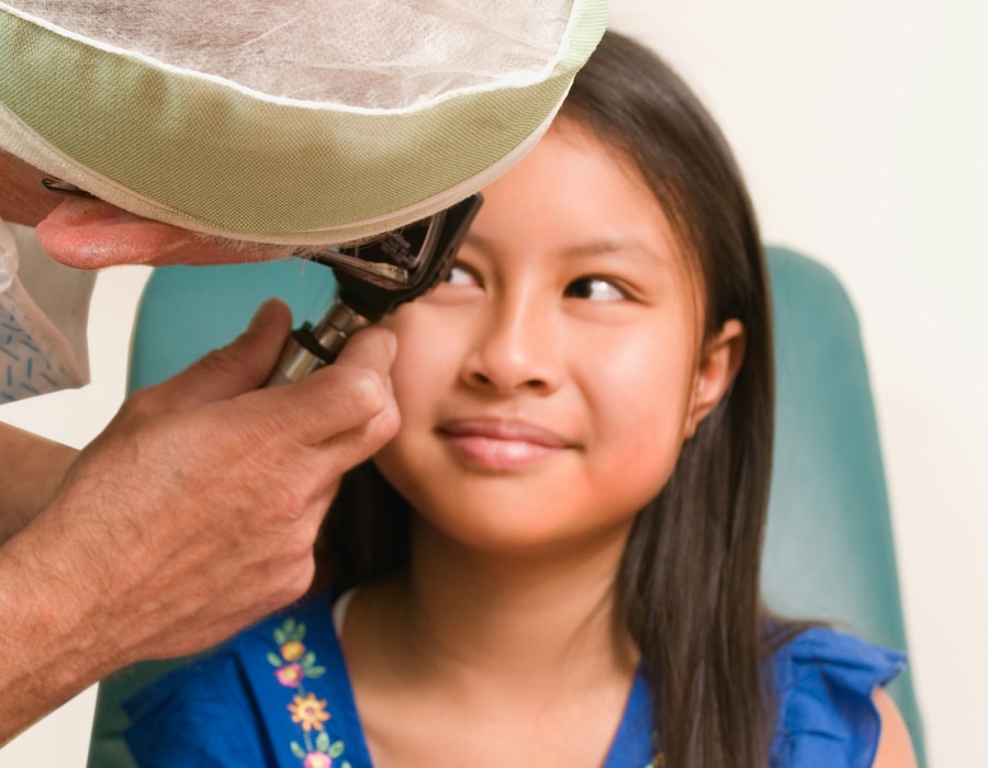 A girl receiving an eye exam from an eyecare professional