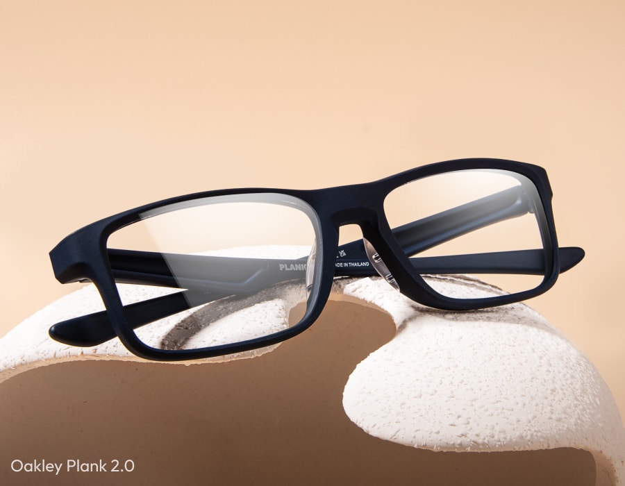 A flatlay of Oakley Plank eyeglasses in the satin black colorway