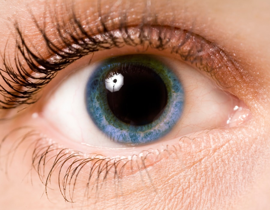 A closeup of a blue eye with a dilated pupil