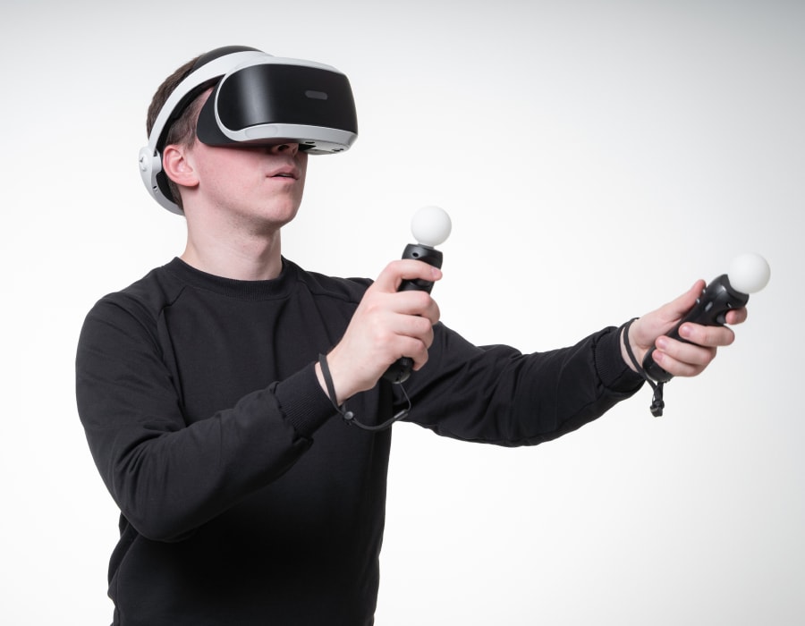 A person using a VR headset and VR controllers