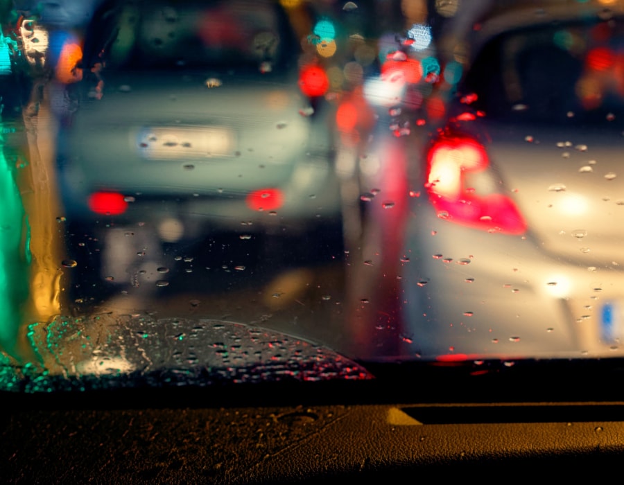 An out of focus view of cars outside of a car window