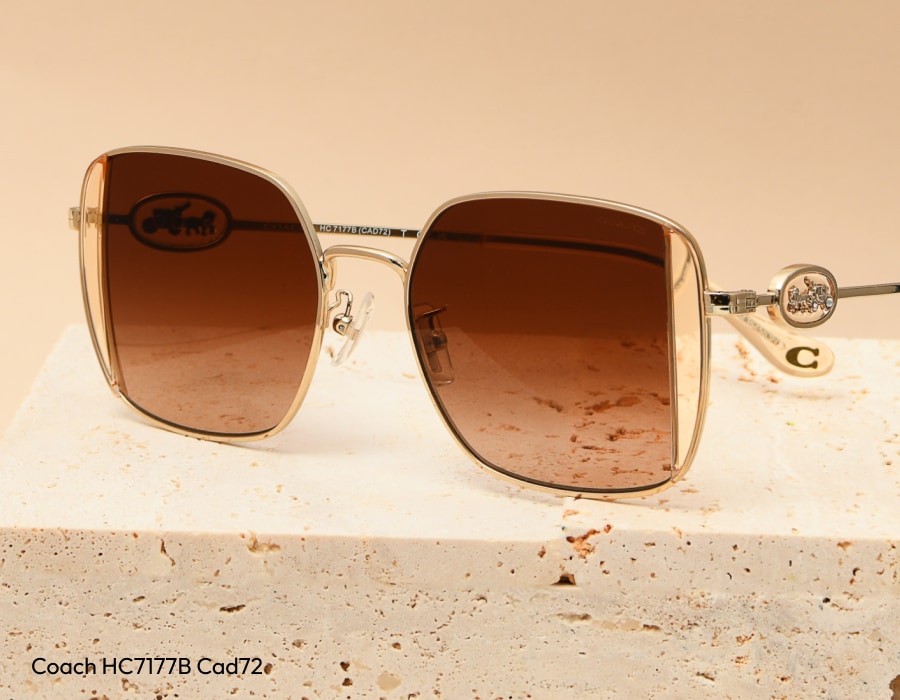 A pair of Coach sunglasses with gradient lenses