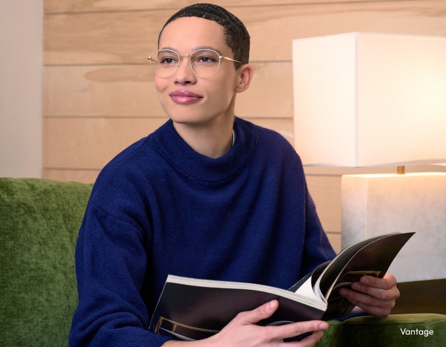 A woman holding a book wearing eyeglasses