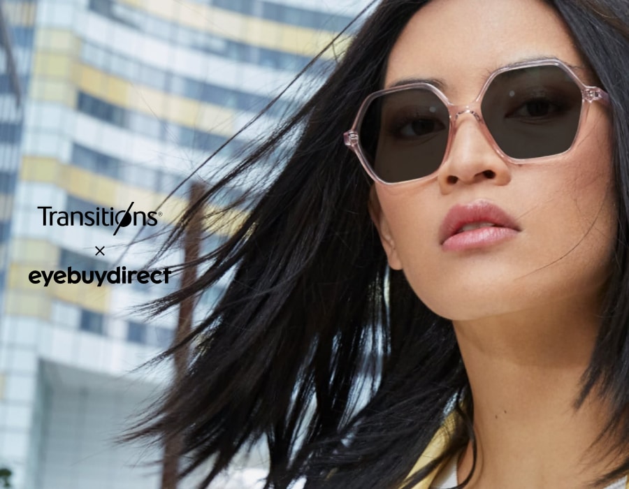 A woman with black hair wearing Transitions sunglasses