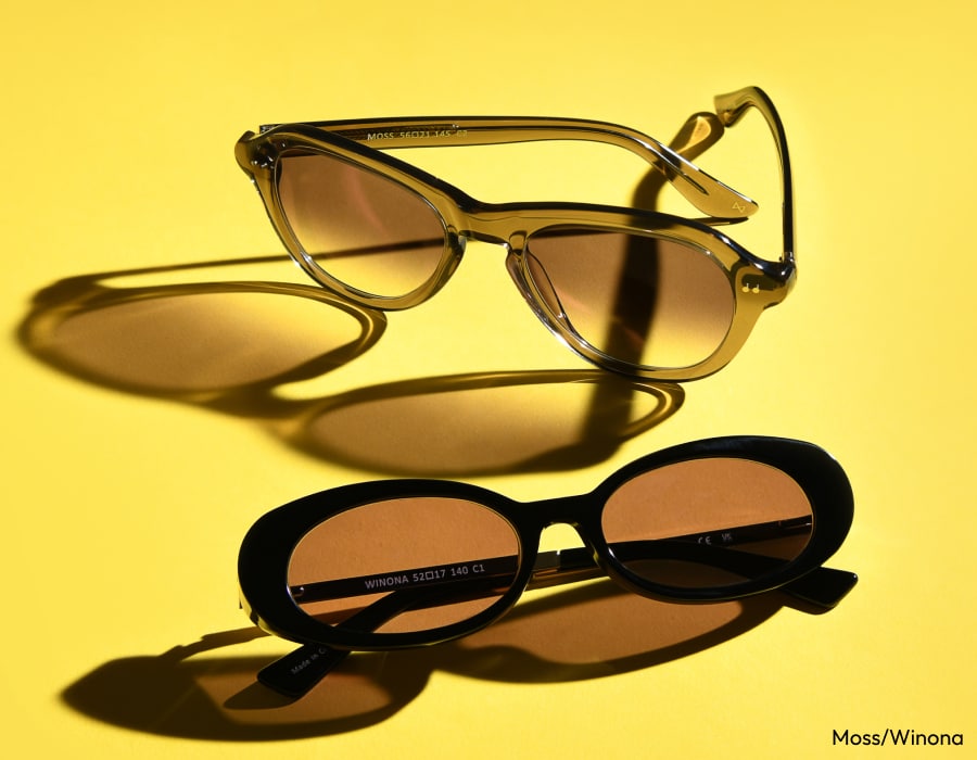 Two pairs of sunglasses on a bright yellow background