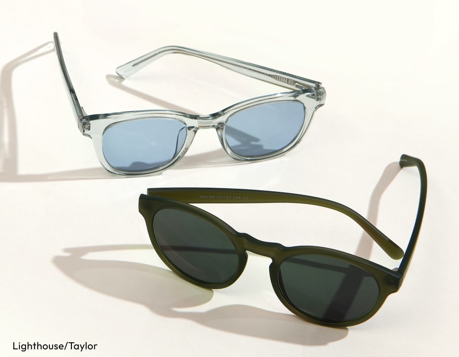 A pair of sunglasses with transparent frames and light blue lenses, and a pair of sunglasses with dark green frames and dark lenses