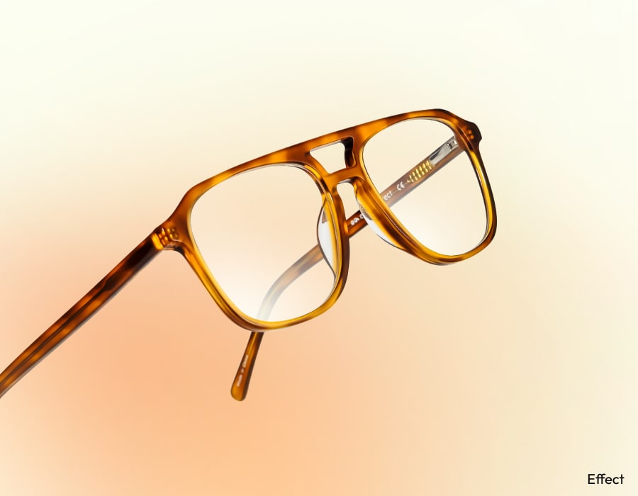 A pair of eyeglasses with orange frames and a double nose bridge