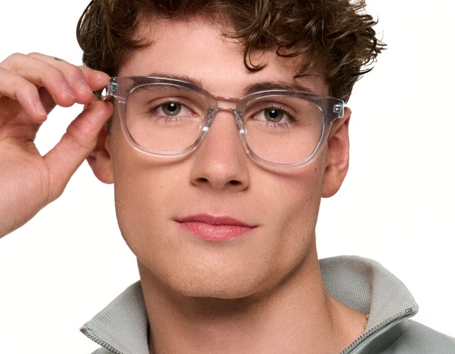 A man with hazel eyes wearing oversized eyeglasses