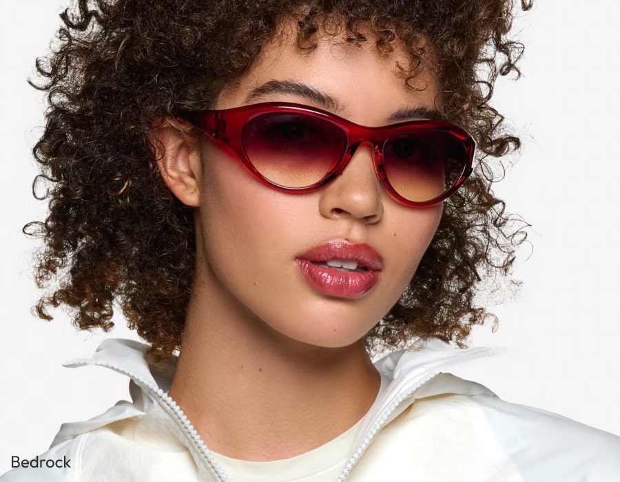 Someone wearing sunglasses with gradiend red-tinted lenses