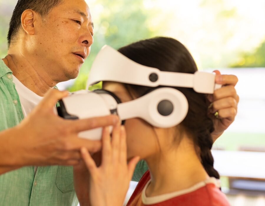 A medical expert helping a woman fit a VR headset
