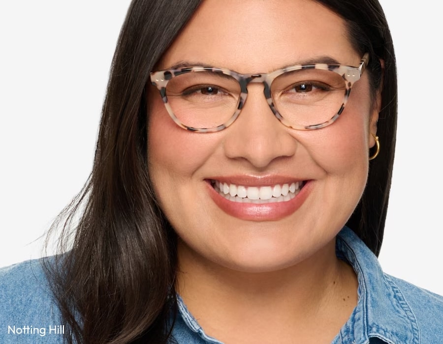 A woman wearing eyeglasses with tortoishell pattern frames