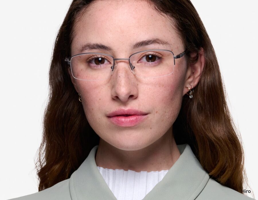 A woman wearing rimless eyeglasses with narrow lenses