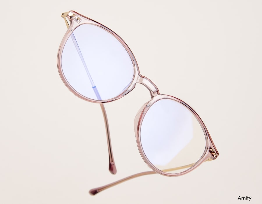 A pair of eyeglasses with translucent, peach colored frames