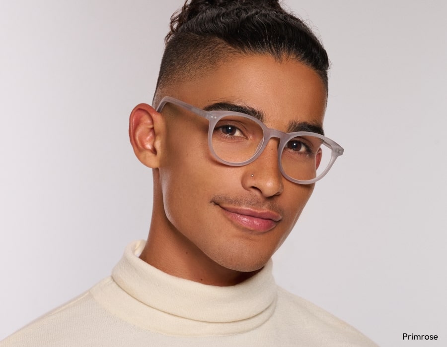 A man with short hair wearing eyeglasses with matte gray frames