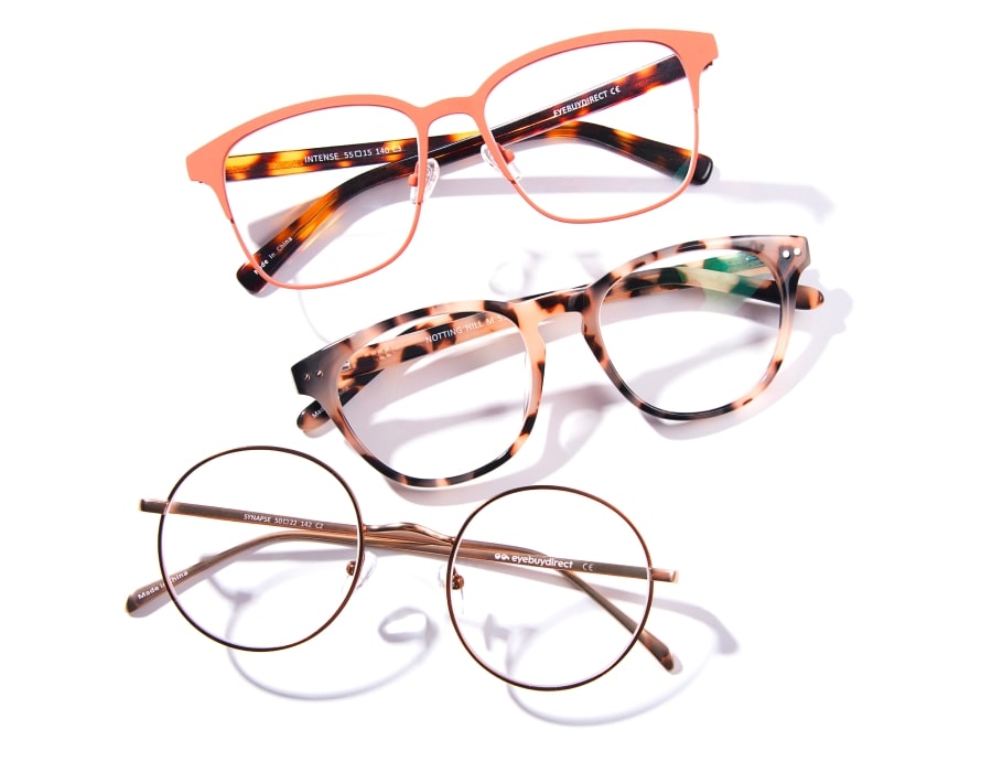 A flatlay of 3 pairs of eyeglasses on a white background