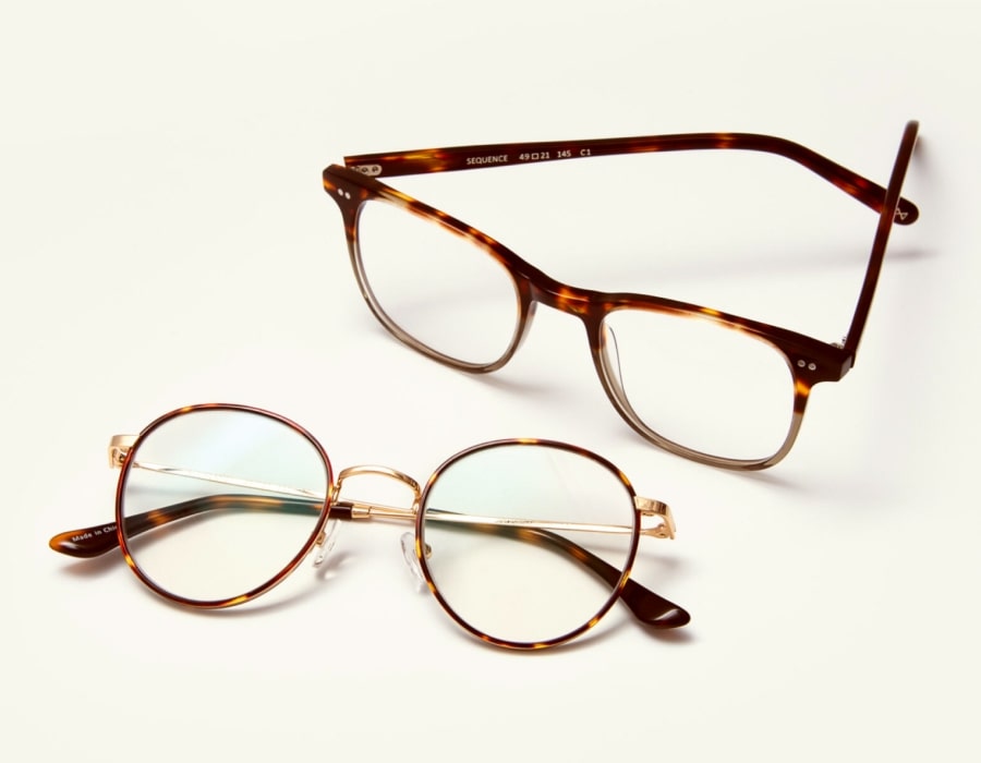 A flatlay of two pairs of tortoise-patterned eyeglasses