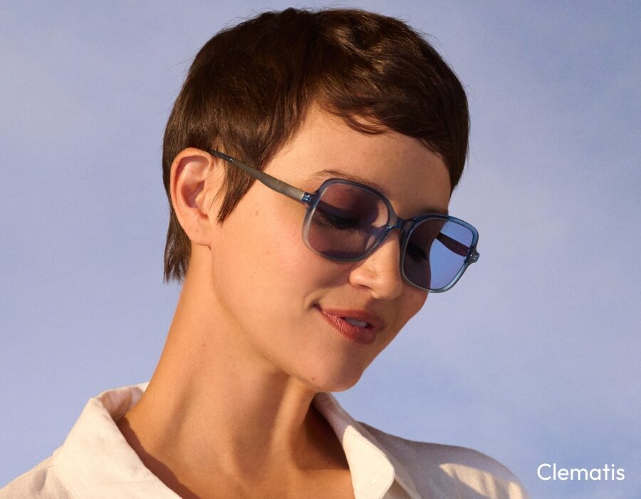 A woman with short hair wearing square sunglasses