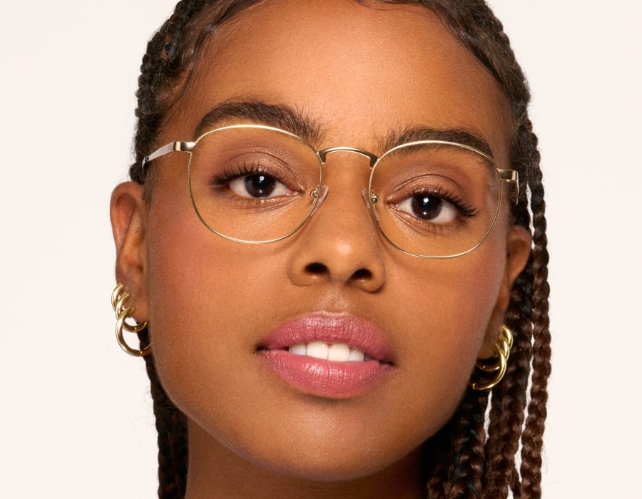 A woman wearing bronze colored wedding glasses