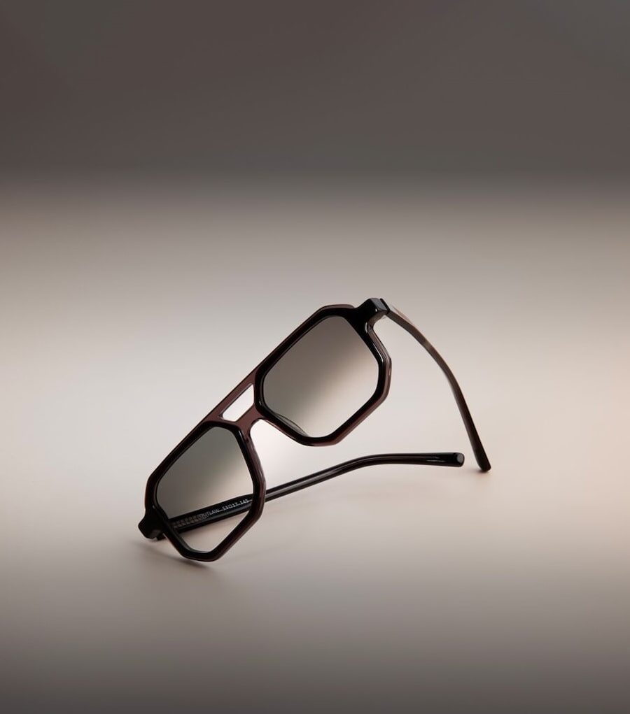A flatlay of black geometric sunglasses