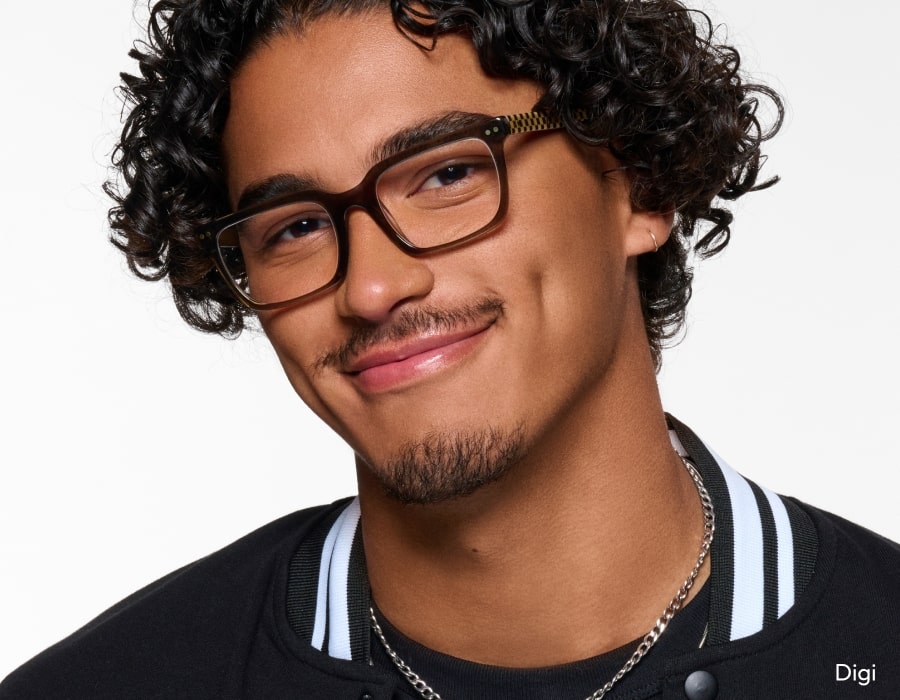 A man smiling wearing eyeglasses with brown frames