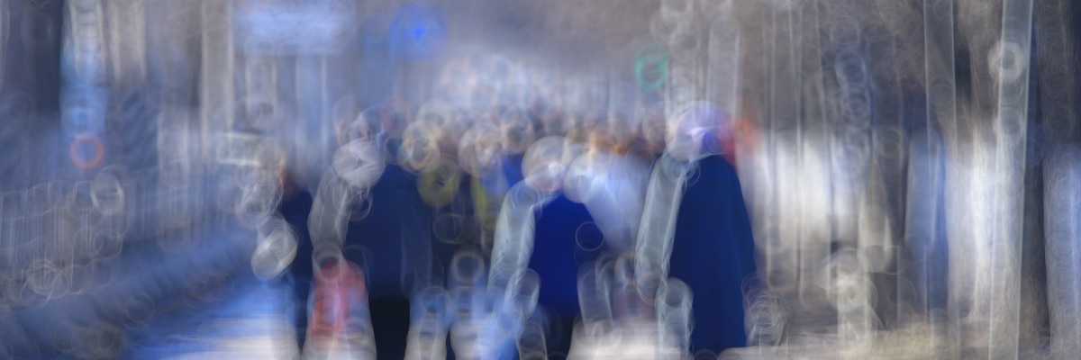 Blurry image of people walking in a street