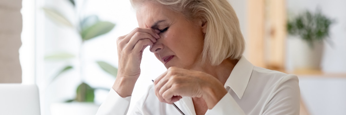 An older women suffering from eye problems
