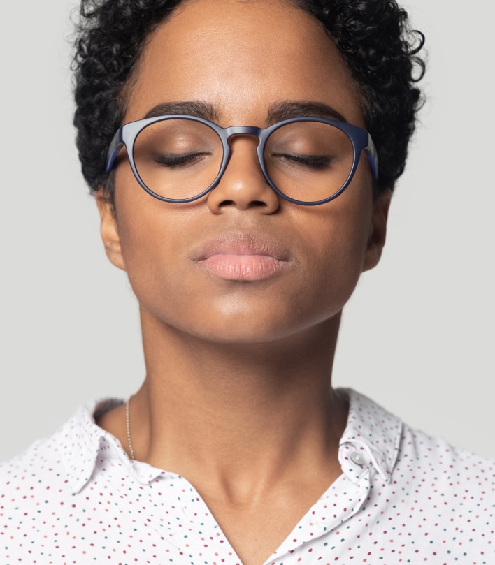 A woman wearing glasses blinking
