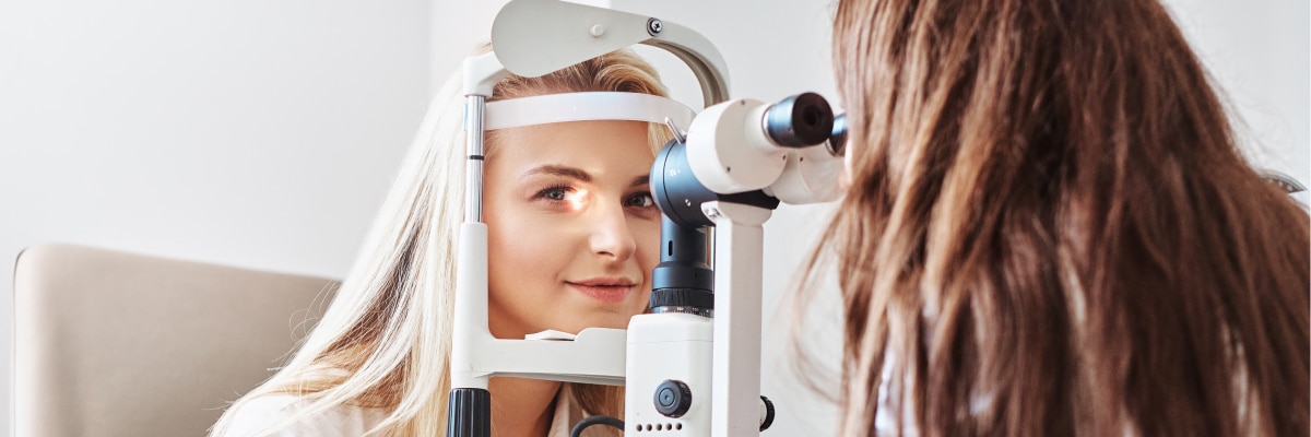 A woman using an eye-testing machine