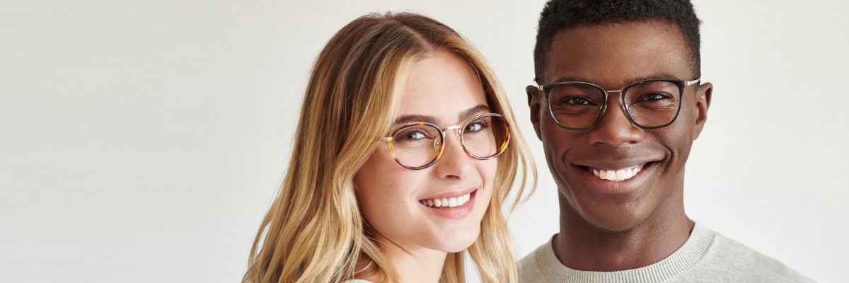 A man and woman wearing reading glasses