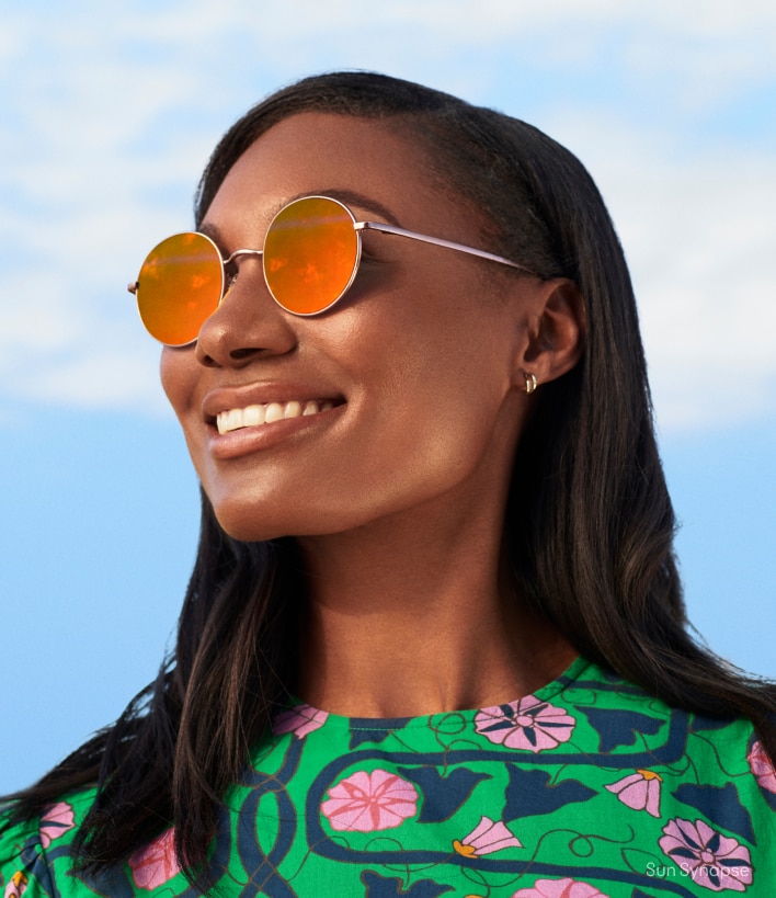 A woman wearing orange-tinted sunglasses