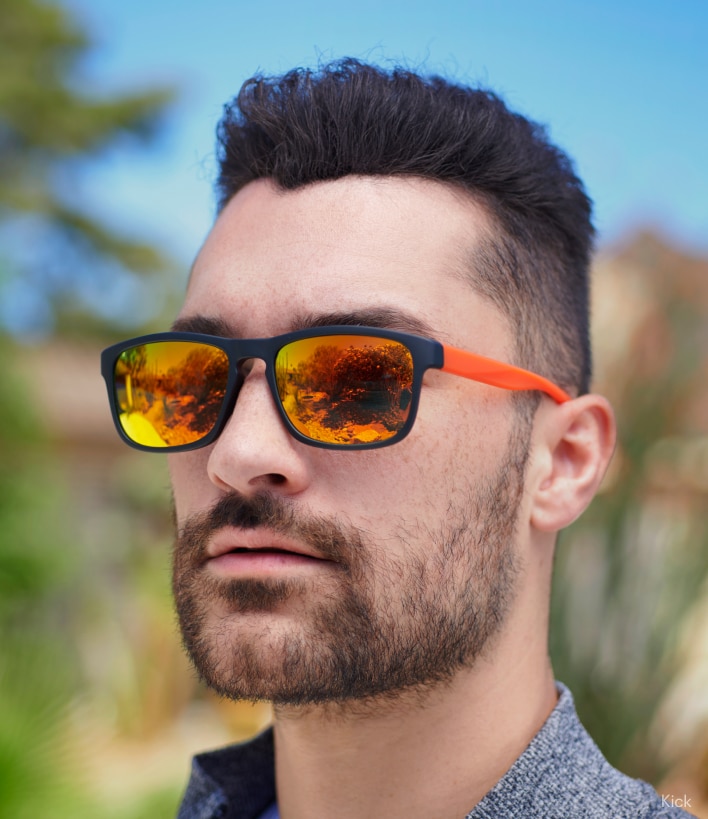 A man wearing orange-tinted sunglasses