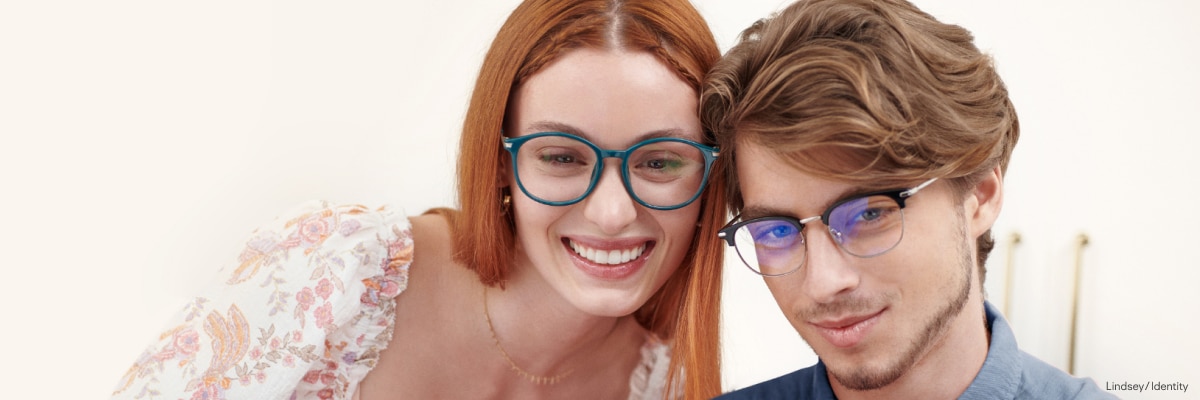 A man and woman wearing blue light glasses