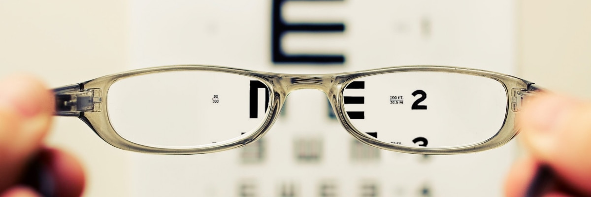 An image of a snellen eye chart through eyeglasses lenses